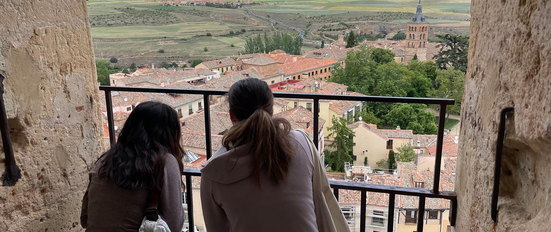 students overlooking european village